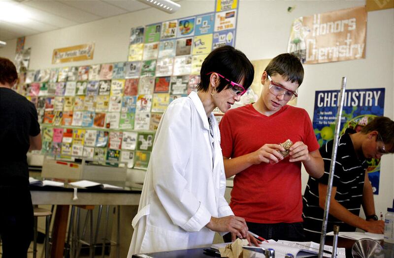 Julie Laub helps her student, A.J. Watts during an AP Chemistry class at Davis High School in Kaysville on Friday, Oct. 26, 2012. Laub earned her master's degree through Western Governors University, which uses competency-based assessments instead of cr
