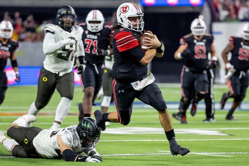 Utah QB Cam Rising runs the ball during the Pac-12 championship game against Oregon at Allegiant Stadium in Las Vegas.