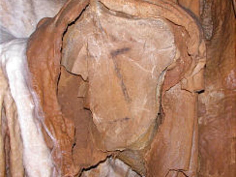 Image from cave is one of the oldest depictions of a human face, scientists say. Cave contained a 27,000-year-old human skeleton.