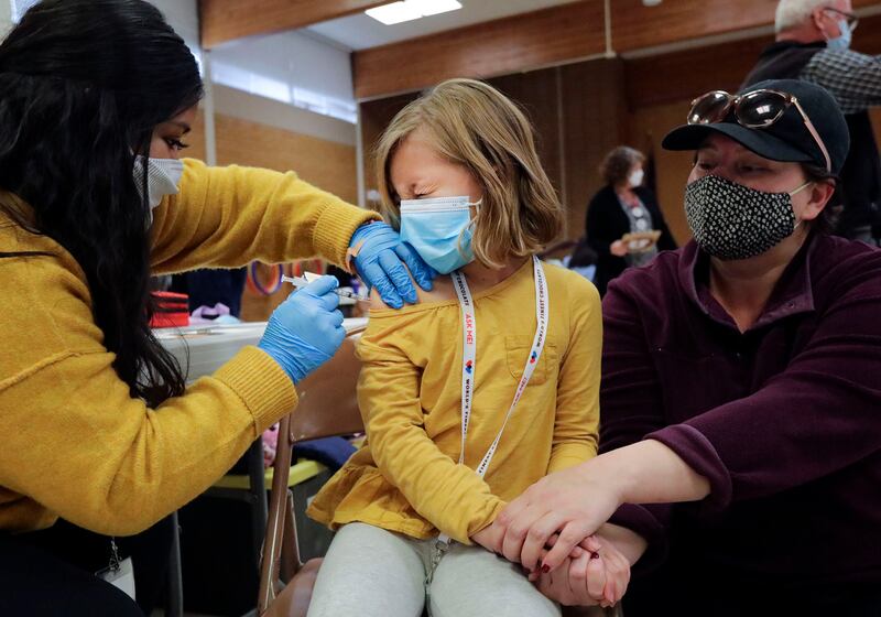 Claudia Ceron, left, gives Etta Bastian, 7, a COVID-19 vaccination in West Valley City on Monday, Nov. 8, 2021.