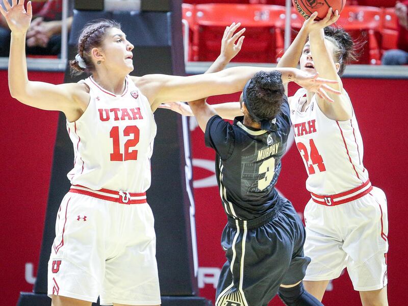 Purdue Boilermakers guard Tiara Murphy (3) attempts a shot but is stifled by Utah Utes forward Emily Potter (12) and guard/forward Tilar Clark (24) as the University of Utah hosts Purdue University at the Huntsman Center in Salt Lake on Monday, Nov. 20, 2