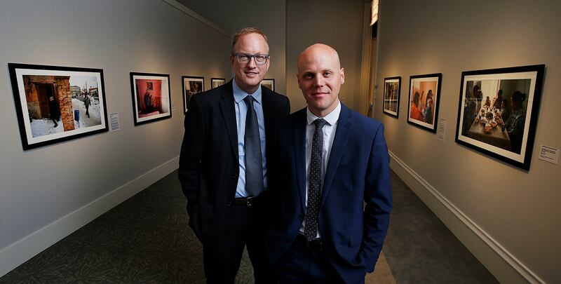 "Light & Life" exhibit photographers Leslie Nilsson, left, and Cody Bell pose for a portrait with some of their photos in the background at the Church History Museum in Salt Lake City on Thursday, May 17, 2018.