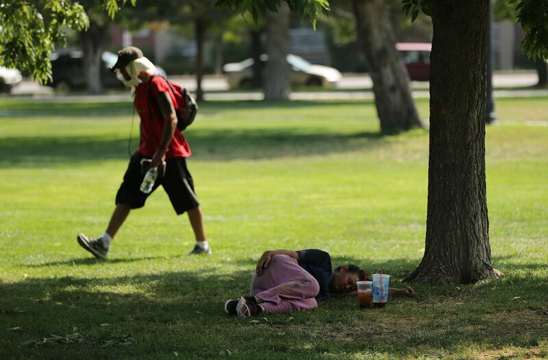 Homeless people rest and walk in Pioneer Park in Salt Lake City on Wednesday, Aug. 1, 2018. The city will install a large lawn in the south-central portion of the park that will include a surrounding walkway, sports field and sports lighting. The construc