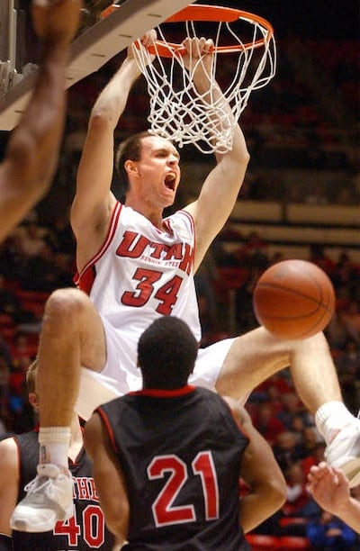 Former Ute Chris Burgess (34) celebrates a dunk over Southern Utah’s Kevin Henry in 2001.