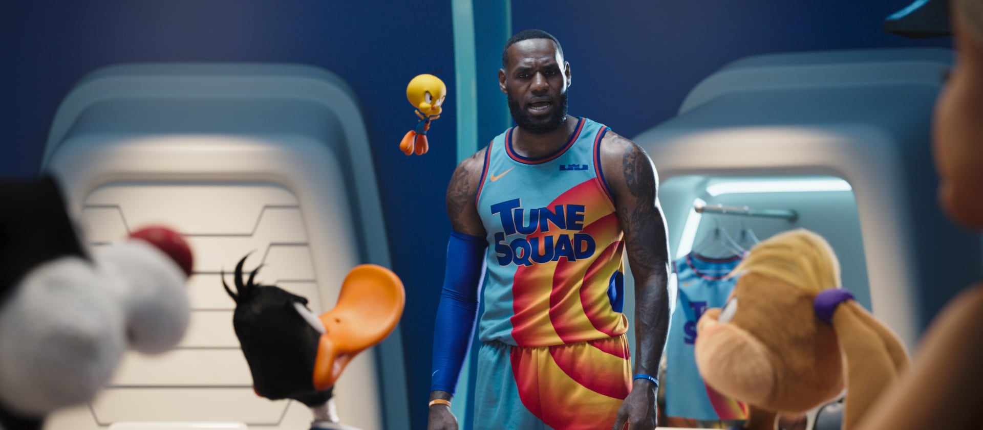 NBA star LeBron James is surrounded by Looney Tunes characters.