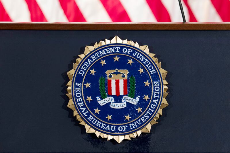An FBI seal appears on a podium before a news conference at the agency’s headquarters in Washington.
