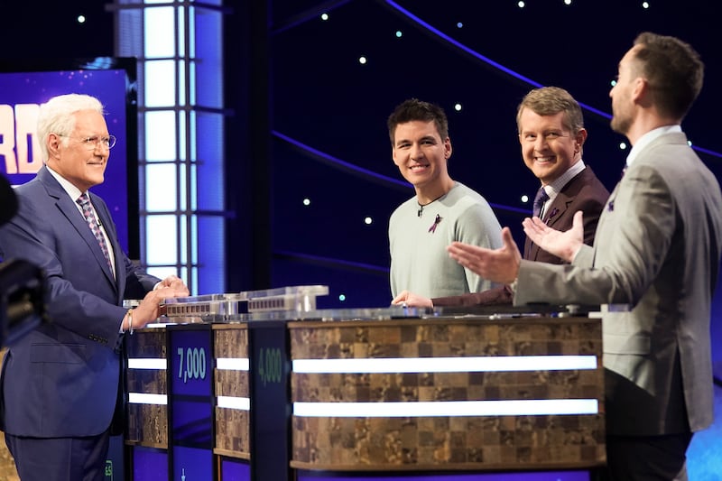 Late “Jeopardy!” host Alex Trebek chats with “Jeopardy! The Greatest of All Time” contestants James Holzhauer, Ken Jennings and Brad Rutter.