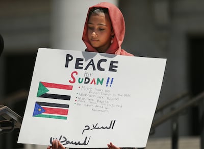 Nawa Alzubaidi holds a sign as March for Refugees hosts a rally for Sudan at the Capitol in Salt Lake City on Saturday, June 29, 2019.