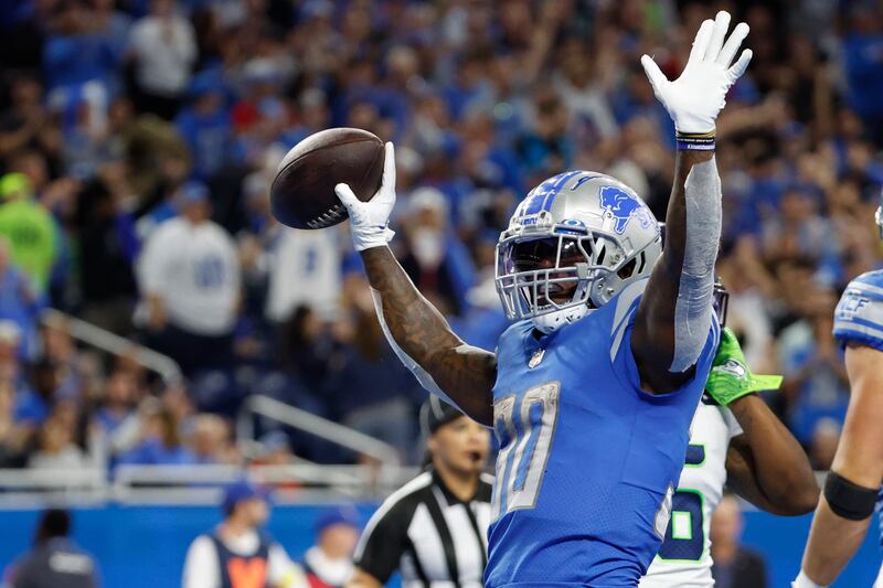 Detroit Lions running back Jamaal Williams (30) celebrates a touchdown in the first half against the Seattle Seahawks during an NFL football game, Sunday, Oct. 2, 2022, in Detroit.