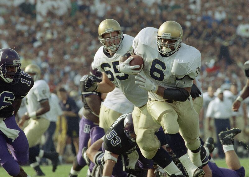 Notre Dame running back Jerome Bettis rushes for a touchdown against Northwestern in Chicago, Sept. 5, 1992. Others are unidentified.
