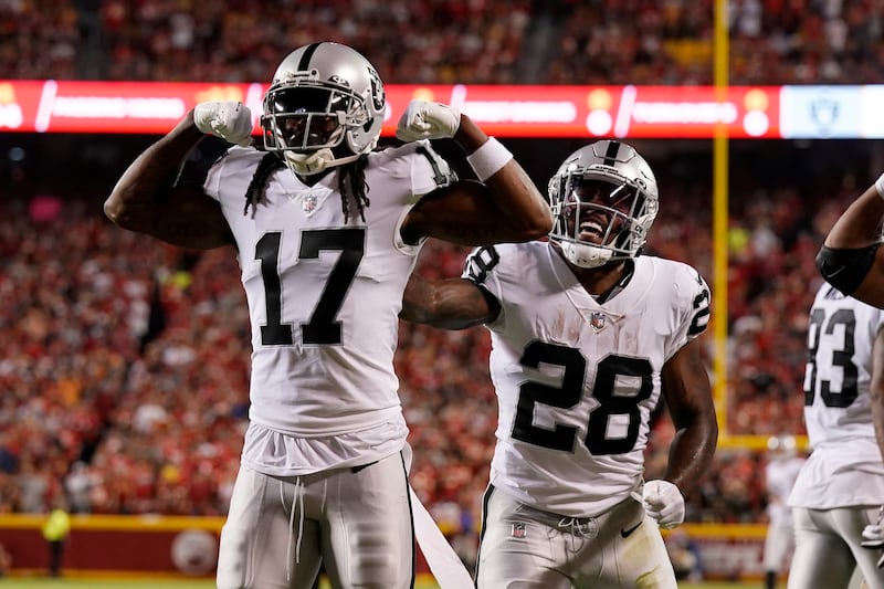 Las Vegas Raiders wide receiver Davante Adams is congratulated by Josh Jacobs after scoring against the Kansas City Chiefs Monday, Oct. 10, 2022, in Kansas City, Mo.