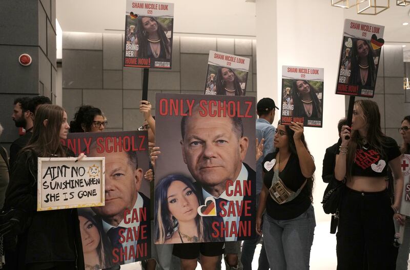 Supporters of missing Israeli Shani Louk hold placards calling for her return on Oct. 17, 2023, at the German Embassy in Tel Aviv.
