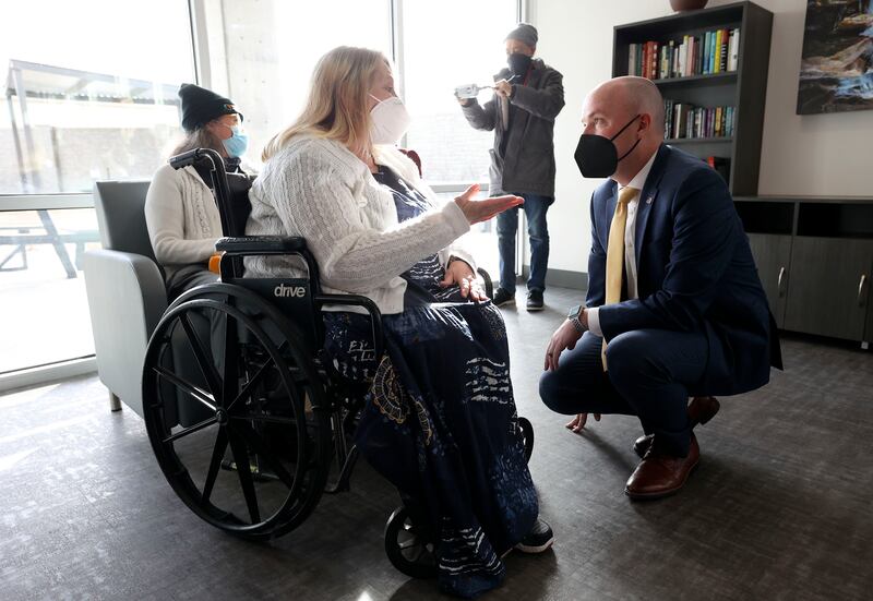 Alma Bennett, Pamela’s Place Apartments resident, talks to Utah Gov. Spencer Cox at a press conference.
