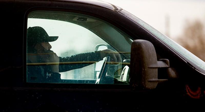 A driver holds his cellphone up to his ear as he drives on State Street in Salt Lake City on Monday, Feb. 25, 2019.