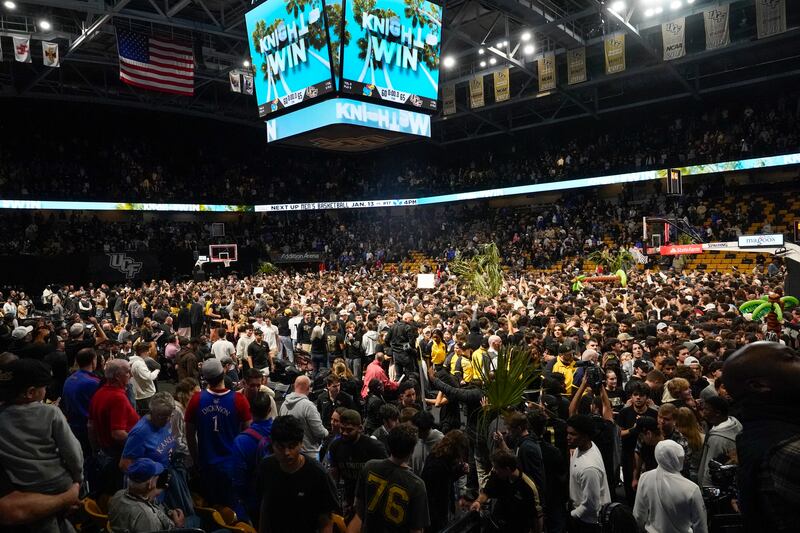 Central Florida fans storm the court after upsetting No. 3 Kansas on Jan. 10, 2024, in Orlando, Fla.