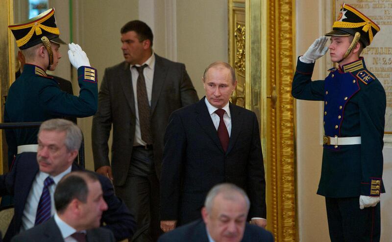 Russian Prime Minister Vladimir Putin, center, enters the The St. George hall to hear Russian President Dmitry Medvedev's addressing the State Council in the Kremlin in Moscow, Russia, Tuesday, April 24, 2012. Medvedev, who will shift into the prime min