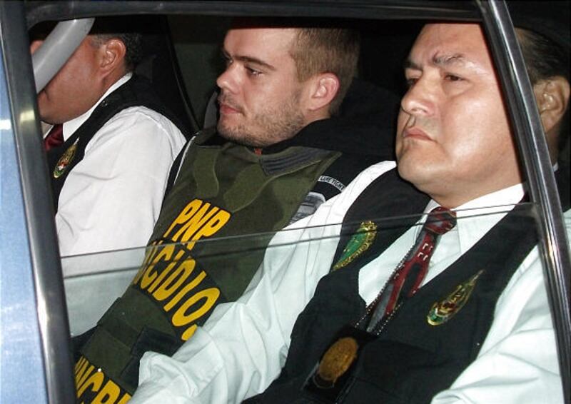 Joran van der Sloot is transported in a police car in Peru on Thursday. Authorities say he confessed to killing a woman.