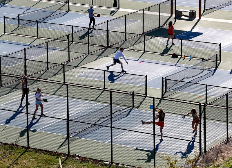 People play on the pickleball and tennis courts at the 11th Avenue Park in Salt Lake City in April 2020.
