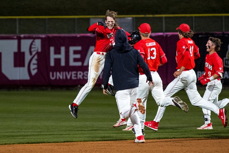 The Utah Utes celebrate their dramatic 8-7 victory over the BYU Cougars at Smith’s Ballpark in Salt Lake City, Utah, on April 19, 2022.