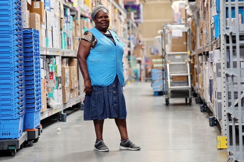 Olivia Sserabira, from Uganda, poses for a photo during her lunch break while she works at Walmart in Salt Lake City shipping packages out to customers on May 19.