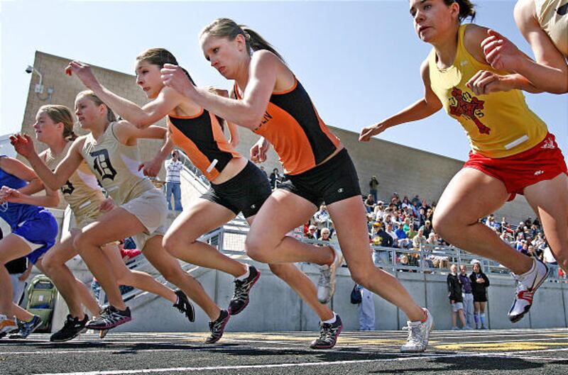Teammates Chloe Calton, center, and Sarah Callister of Ogden High compete in the 1,600.