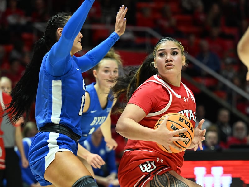 Utah Utes forward Alissa Pili (35) looks one way and goes the other on BYU Cougars forward Lauren Gustin (12) as Utah and BYU women play at the Huntsman Center in Salt Lake City on Saturday, Dec. 2, 2023.