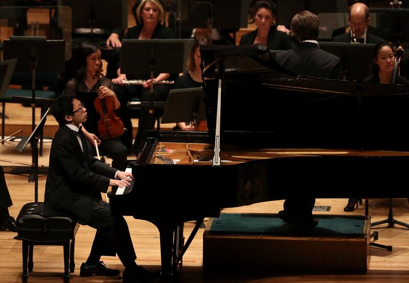 John Zhao plays the piano with the Utah Symphony during the 59th annual Salute to Youth concert, an event where young musicians perform classical masterpieces as soloists, at Abravanel Hall in Salt Lake City on Tuesday, Sept. 11, 2018.