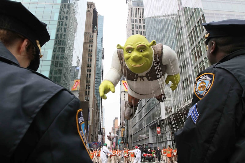Members of the New York Police Department stand by as the Shrek balloon at the Macy’s Thanksgiving Day Parade.