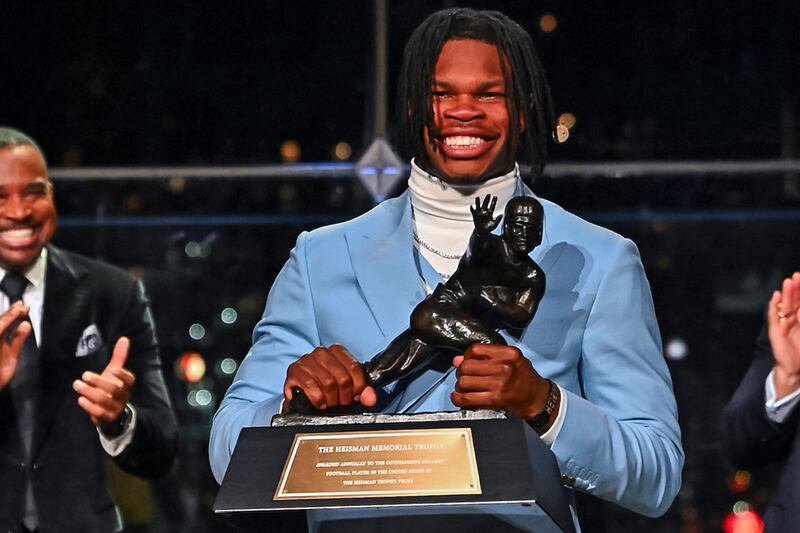 Colorado’s Travis Hunter holds the trophy after winning the Heisman Trophy as the outstanding player in college football, Saturday, Dec. 14, 2024, in New York.