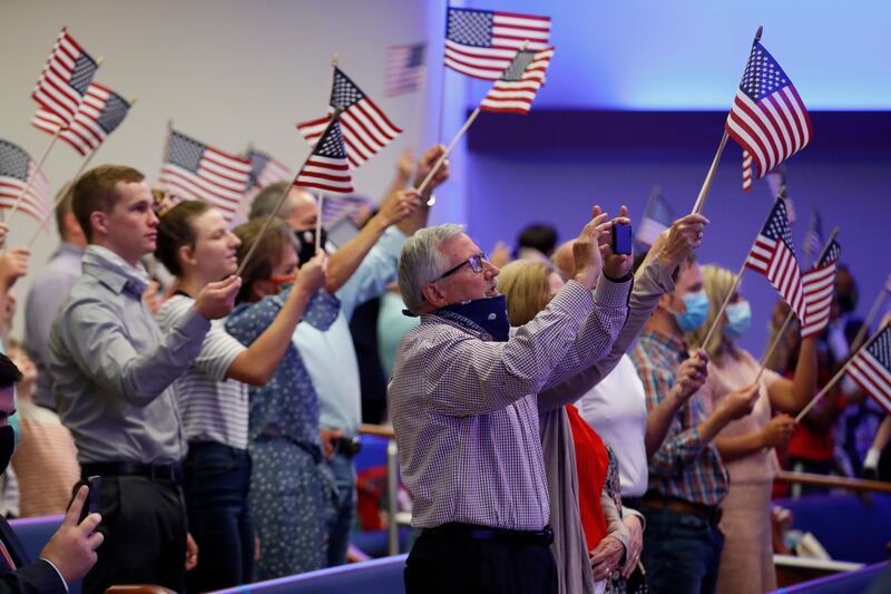 Attendees wave flags before then-Vice President Mike Pence made comments at First Baptist Church Dallas, Sunday, June 28, 2020.