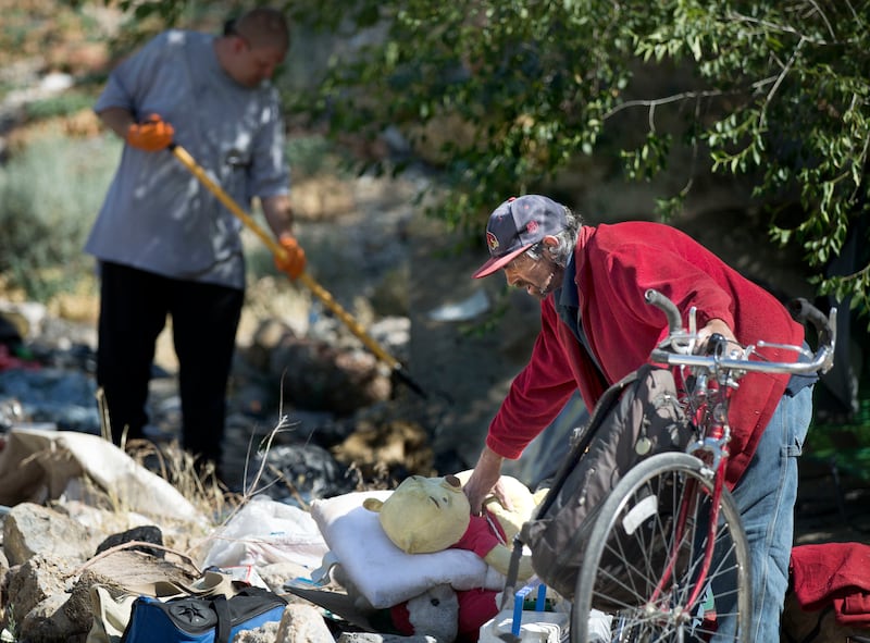 Richard Smith packs up what he can carry during a cleanup of homeless camps located east of Victory Road in the foothills north of Salt Lake City on Thursday, June 14, 2018. Smith has been living in the Victory Road area for nine years.