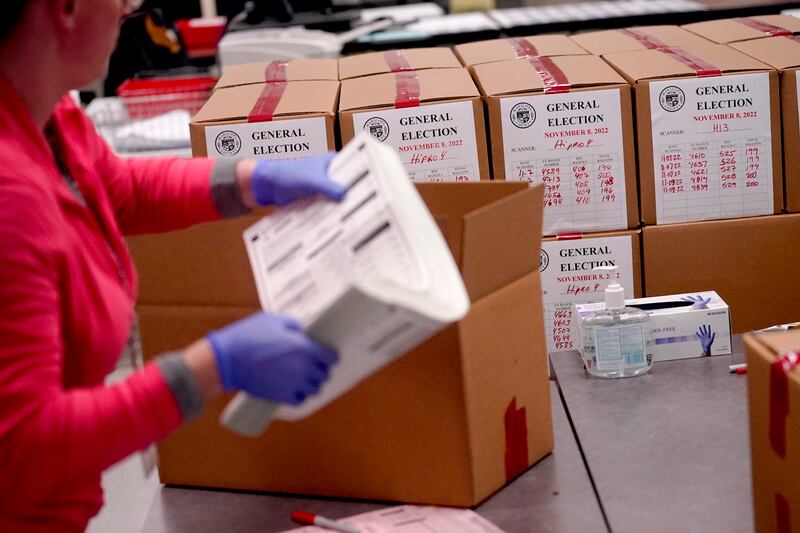 An election worker boxes tabulated ballots inside the Maricopa County Recorders Office on Wednesday, Nov. 9, 2022.