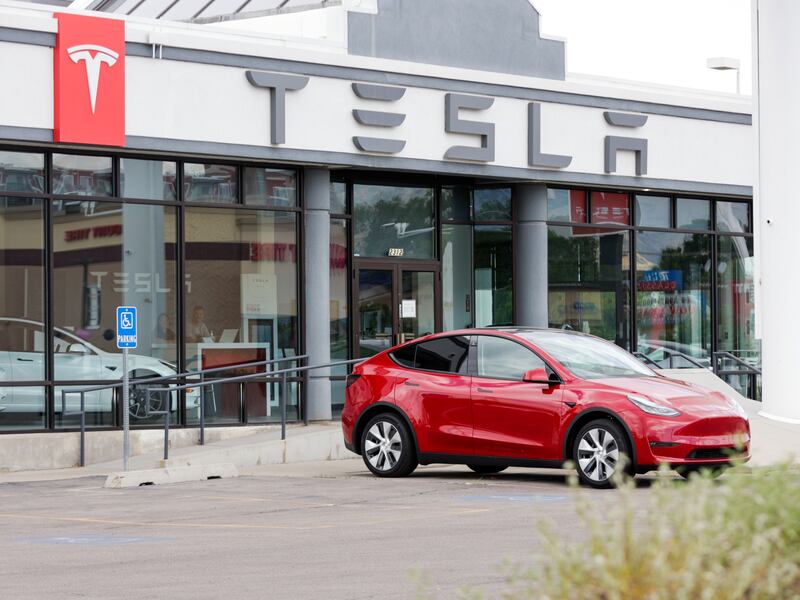 A Tesla sits outside a Tesla dealership in Salt Lake City on July 12, 2022.
