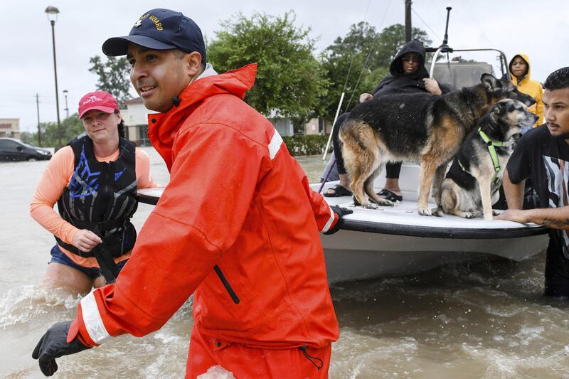 Volunteers and first responders work together to rescue residents from rising flood waters in Houston on Tuesday, Aug. 29, 2017. Forecasters expect the storm to linger over the Gulf before heading back inland east of Houston sometime Wednesday. The syst