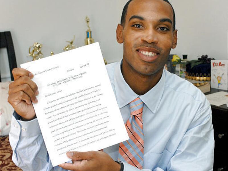 Genarlow Wilson displays the Georgia Supreme Court's decision that released him from prison.