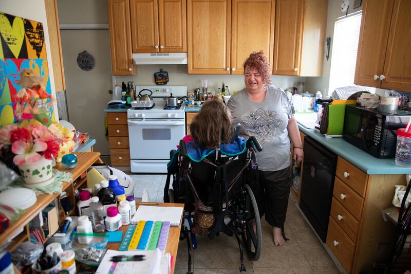 Kira Volar cares for her sister Tara, Saturday, August 4, 2018, in their home outside Sacramento, Calif. Kira is a 47-year-old full-time caregiver to her sister, who is paralyzed and has an intellectual disability. Kira has made caregiving her life's miss