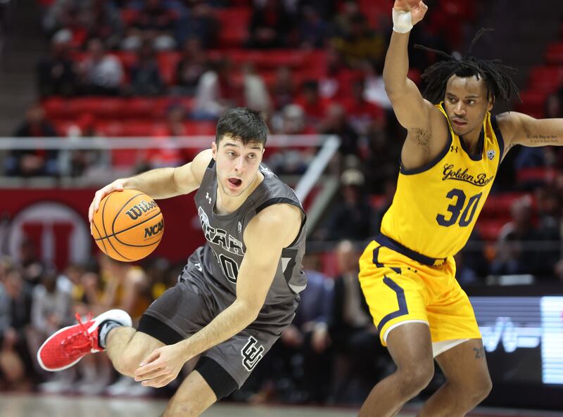 Utah Utes guard Lazar Stefanovic drives on California Golden Bears guard Wrenn Robinson in Salt Lake City, Feb. 5, 2023.