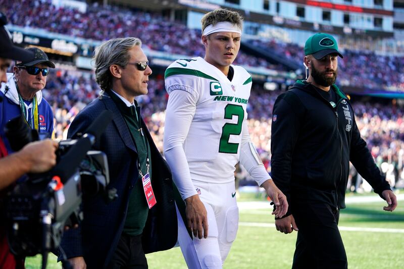 New York Jets quarterback Zach Wilson (2) is escorted to the locker room after an apparent injury.