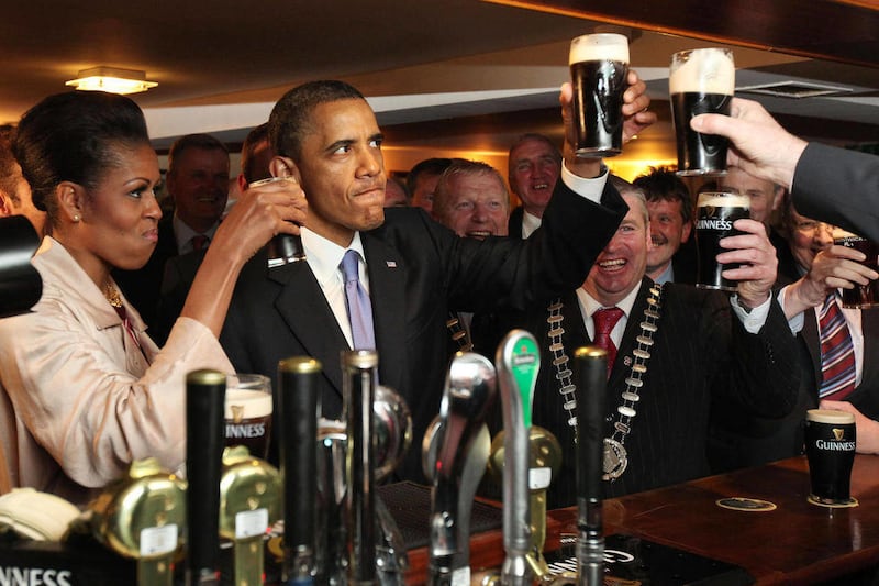 U.S. President Barack Obama and first lady Michelle Obama drink Guinness beer as they meet with local residents at Ollie Hayes pub in Moneygall, Ireland, the ancestral homeland of his great-great-great grandfather, Monday, May 23, 2011. (AP Photo, Pool)