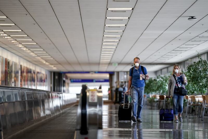Siblings Robert Olson, of Farmington, and Carole Larson, of Logan, walk through Terminal 1 at Salt Lake City International Airport.
