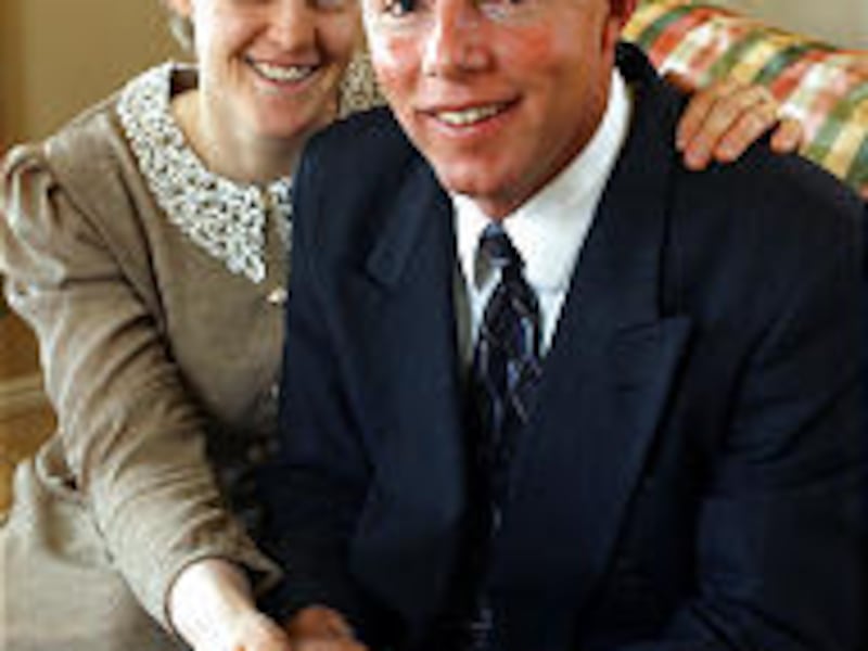 Suzie Holm, sister of Rod Holm's underage third wife, and Rod Holm smile together before St. George court session in 2002.