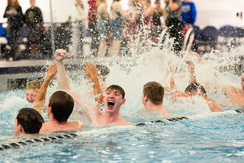 Crimson Cliff High School’s men’s swim team jumps into the pool to celebrate taking first place at the 4A State Swim Meet at the Brigham Young University Richards Building in Provo on Saturday, Feb. 17, 2024.
