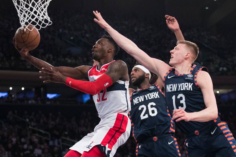 Washington Wizards forward Jeff Green (32) goes to the basket past New York Knicks center Mitchell Robinson (26) and forward Henry Ellenson (13) during the first half of an NBA basketball game, Sunday, April 7, 2019, at Madison Square Garden in New York.