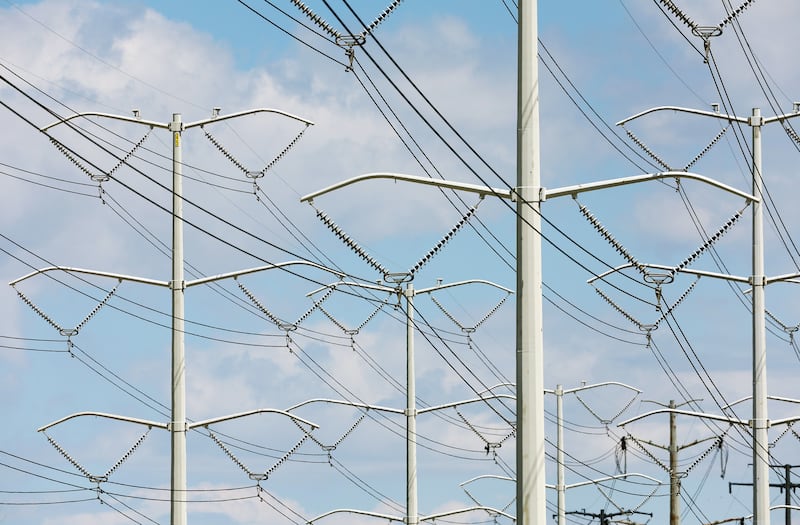 High-tension power lines run along Wright Brothers Drive near the Salt Lake City International Airport on May 24, 2022.