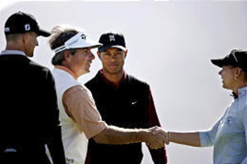 Fred Couples, left, shakes hands with Annika Sorenstam as Tiger Woods and Adam Scott look on after the first playoff hole.