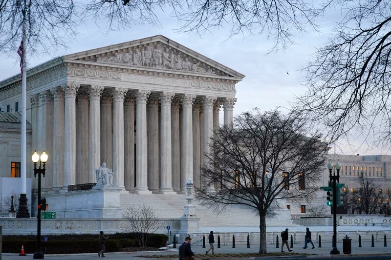 Pedestrians walk past the Supreme Court building on Capitol Hill.