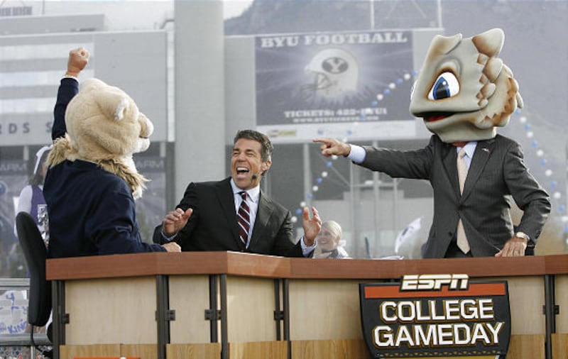 Former BYU football coach LaVell Edwards, left, in a Cosmo head, Chris Fowler and Lee Corso, in the TCU mascot head, joke during the "GameDay" broadcast in Provo Saturday.