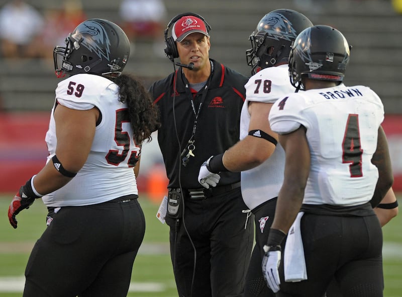 Southern Utah head coach Ed Lamb, center, talks with his players near the sidelines in the first quarter of an NCAA college football game Thursday, Aug. 29, 2013 in Mobile, Ala.  (AP Photo/G.M. Andrews)