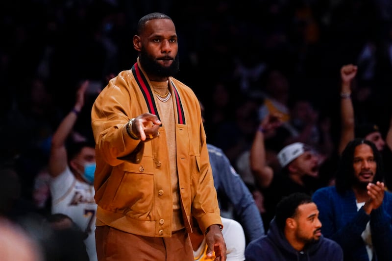 Los Angeles Lakers’ LeBron James celebrates during an NBA basketball game against the Charlotte Hornets in Los Angeles.