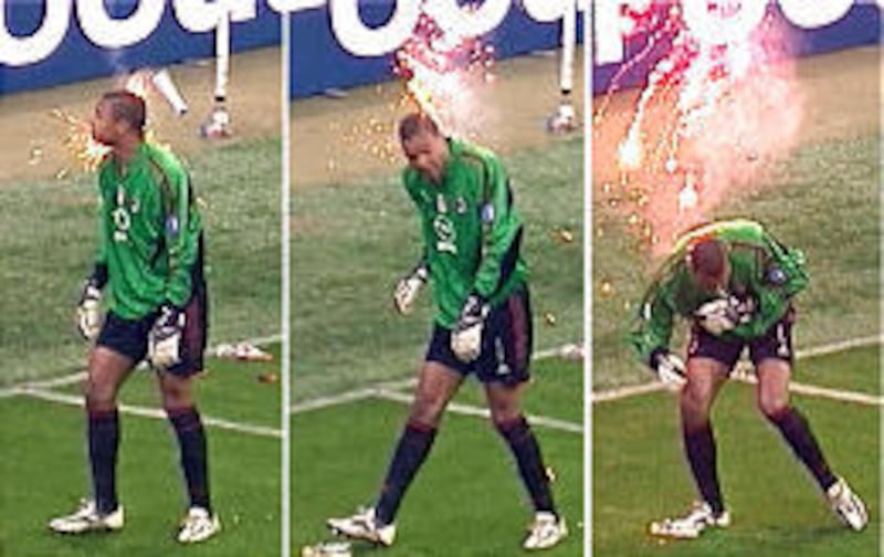 This sequence from TV shows AC Milan Brazilian goalkeeper Dida hit by a flare during the Champions League quarterfinal's second leg match at the San Siro stadium in Milan, Italy. When the disruptions continued unabated, the referee stopped the match when